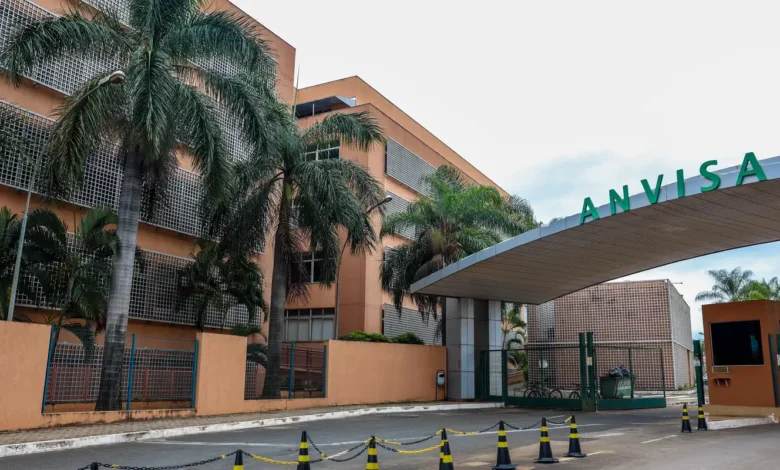 Frasco de medicamento e instalações da Anvisa em destaque