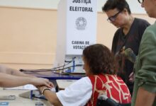 Idoso utilizando urna eletrônica durante votação